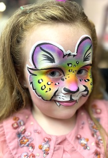 Girl with a rainbow leopard face painting in Stafford